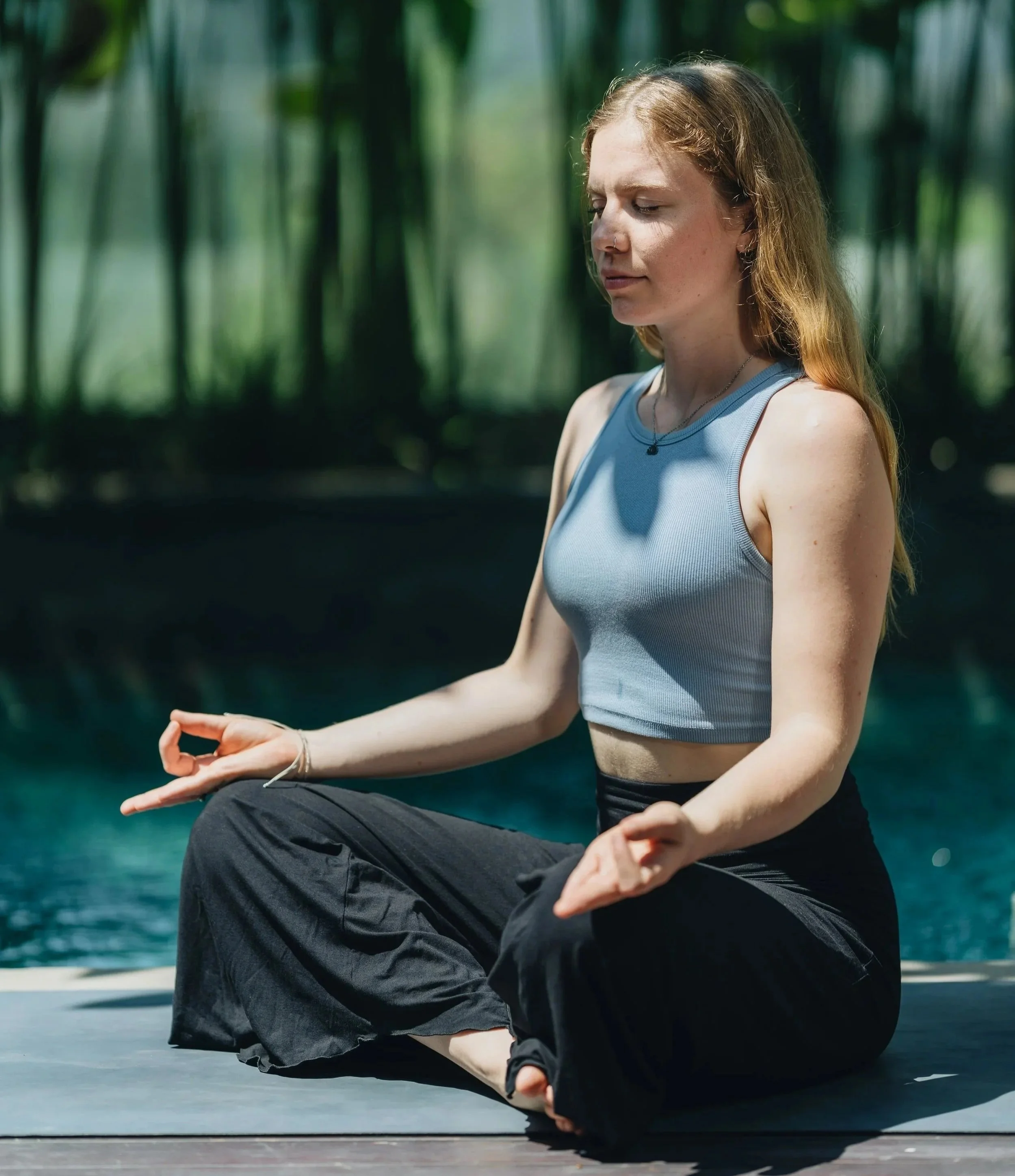 Woman with blond hair meditating for stress relief in nature