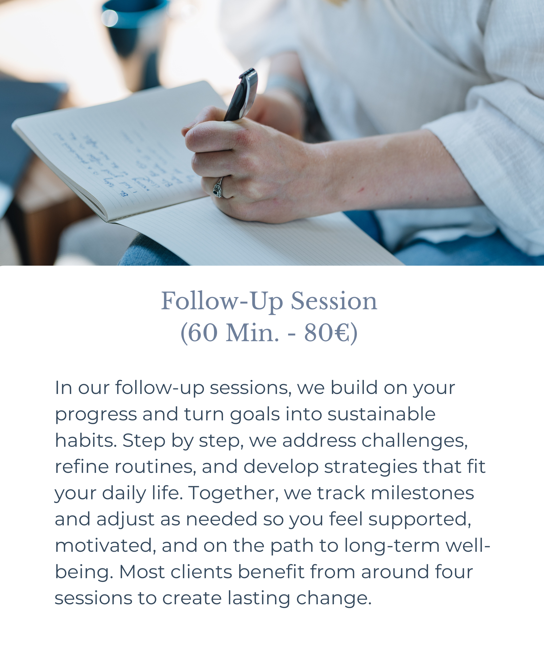 A person writing notes in a notebook with a pen, wearing a white shirt with rolled-up sleeves.