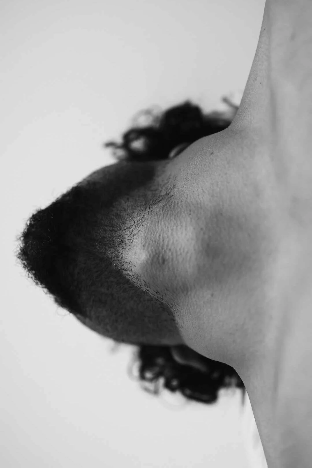 Close-up black-and-white photo of a person's nose and lips in profile view.