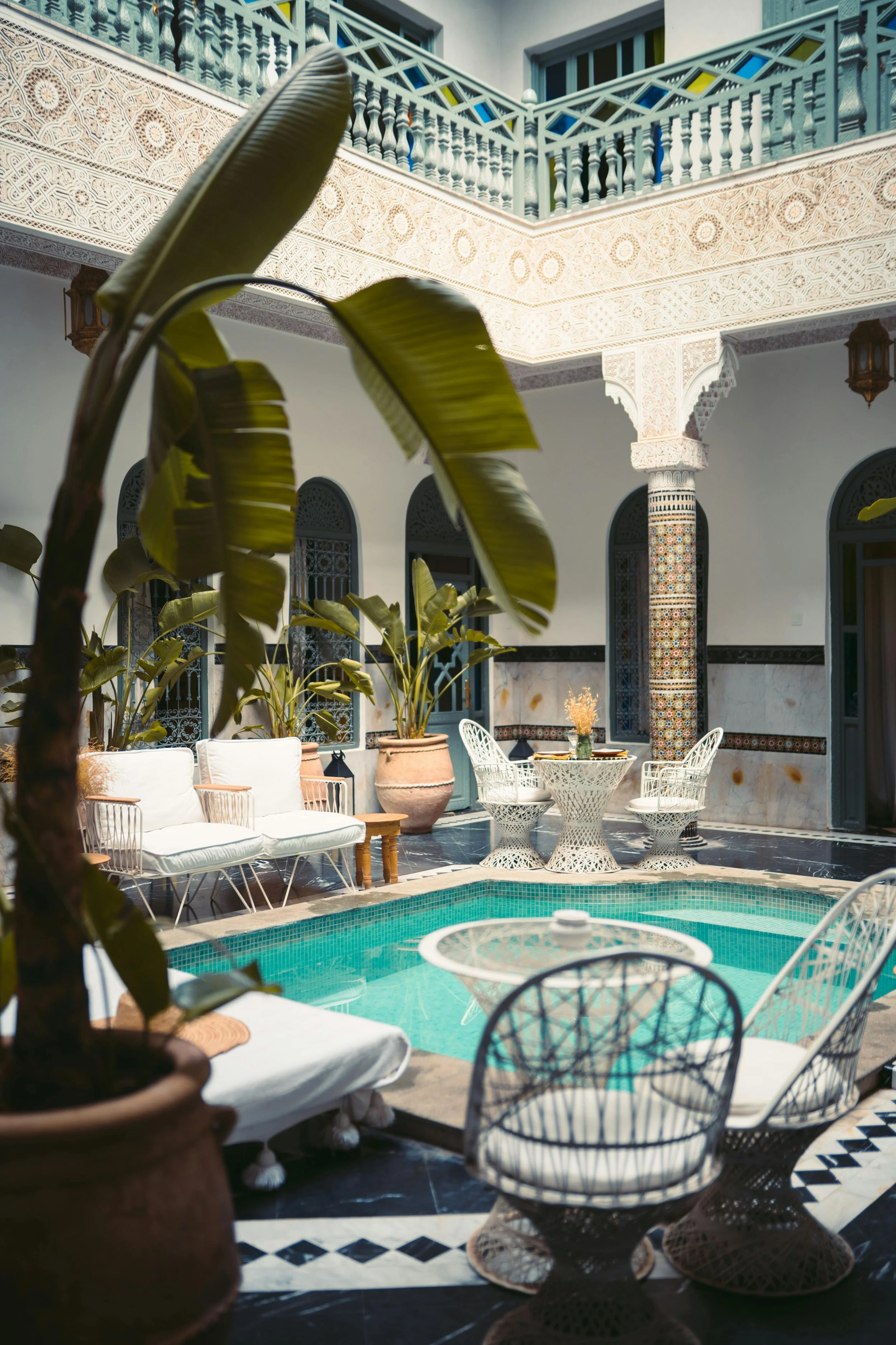 Comfortable seating areas welcome guests around the plunge pool in the courtyard of a luxury riad in Morocco