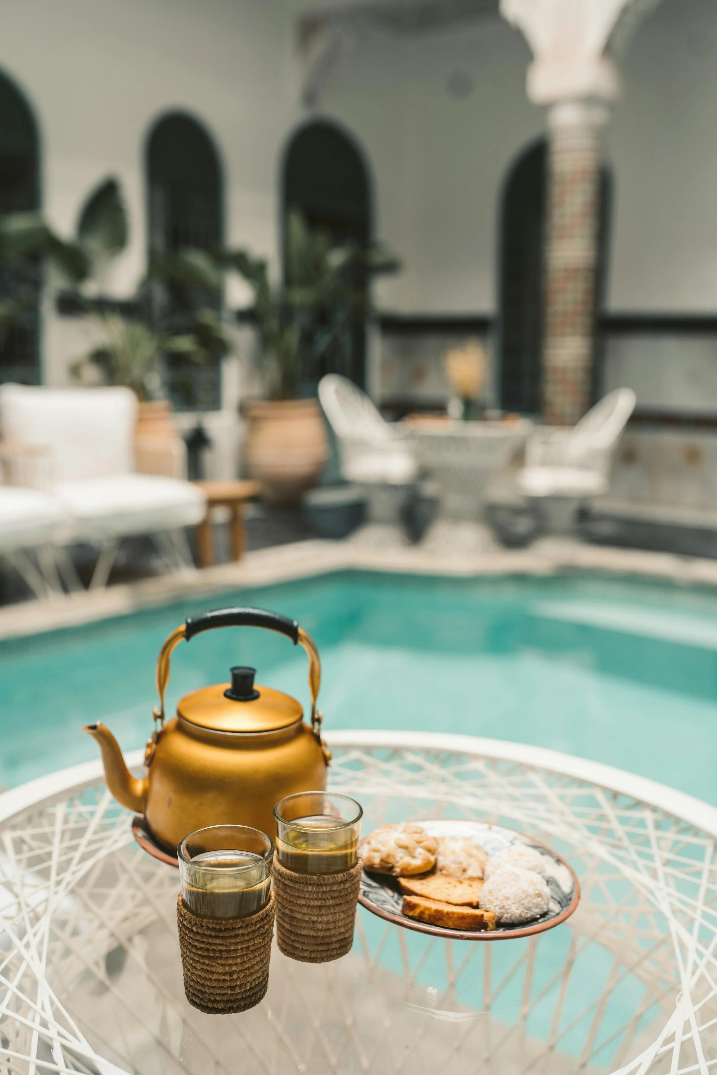 Tea and sweets ready pool-side at a luxury riad in Morocco