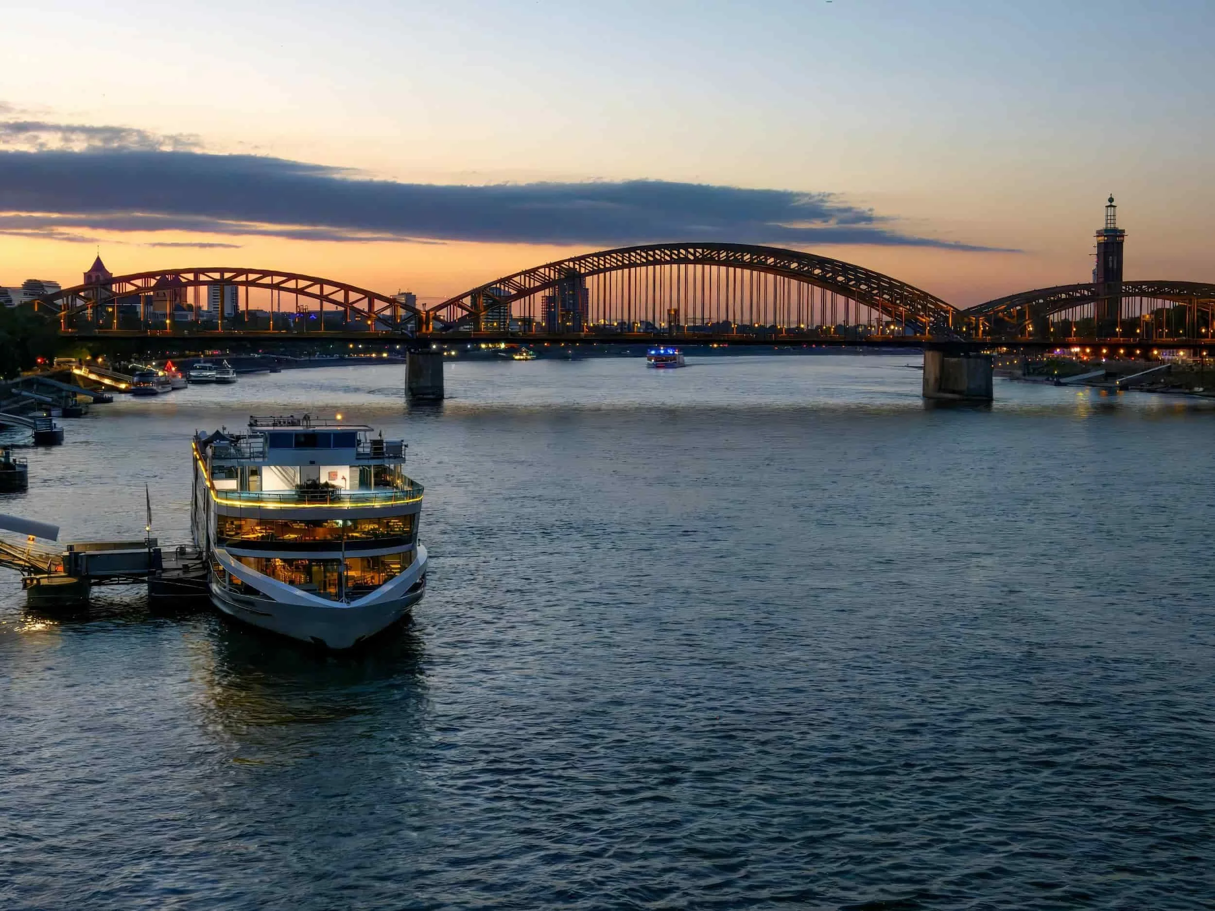 Luxury river cruise docked at sunset in Cologne, Germany, on the Rhine River