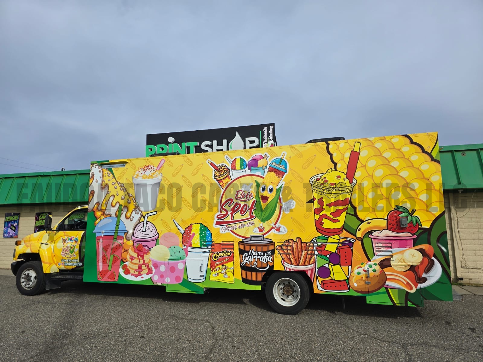 Colorful food truck decorated with illustrations of ice cream, popsicles, juice drinks, snacks, and desserts on a yellow background.