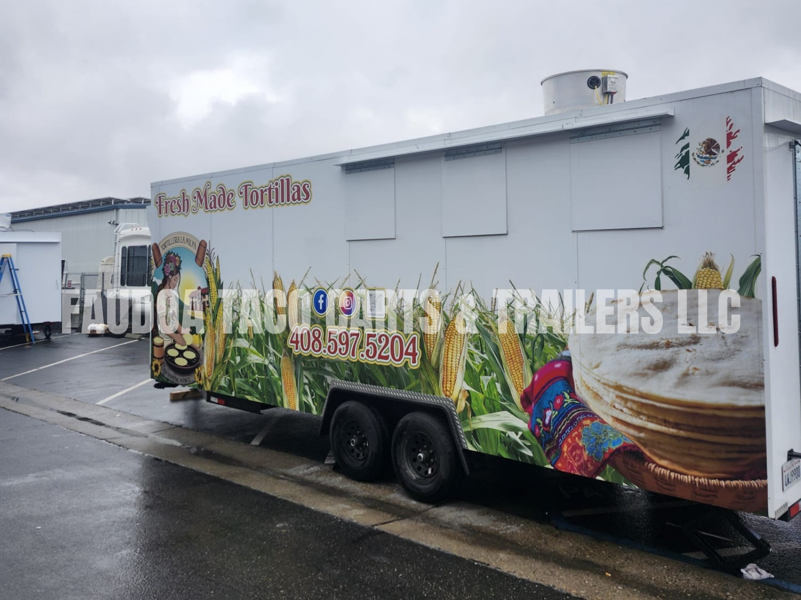 Food truck decorated with images of corn, tortillas, and traditional Mexican embroidery, advertising fresh-made tortillas and displaying a contact number, parked in a rainy lot.