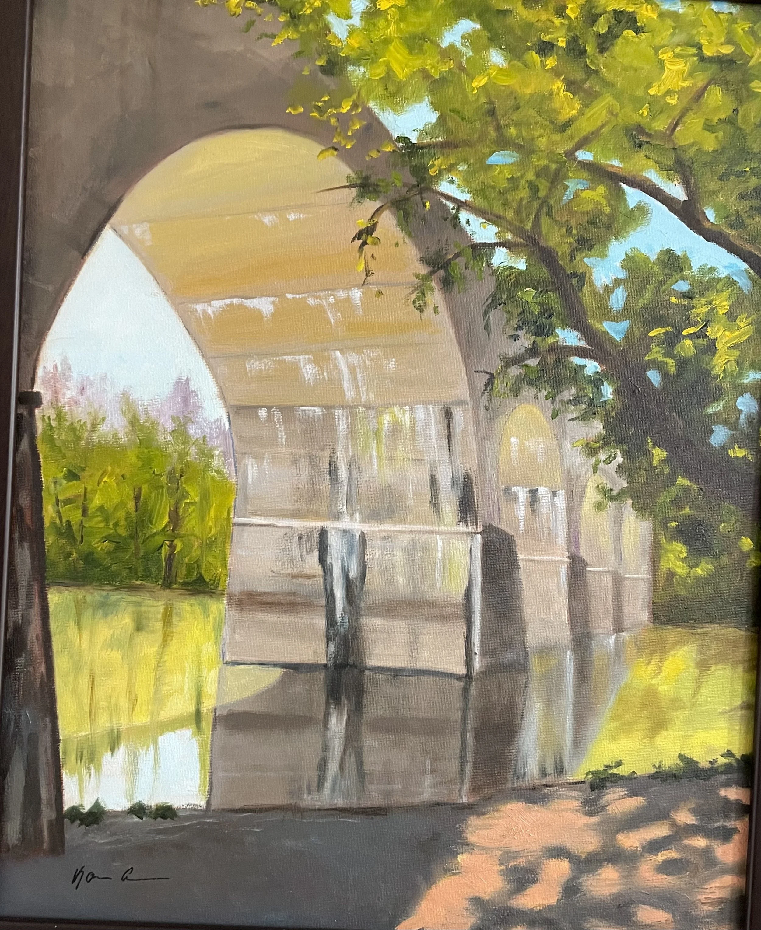 A painting of a bridge over a calm river, viewed from underneath through an archway framed by green trees, with sunlight casting reflections on the water.