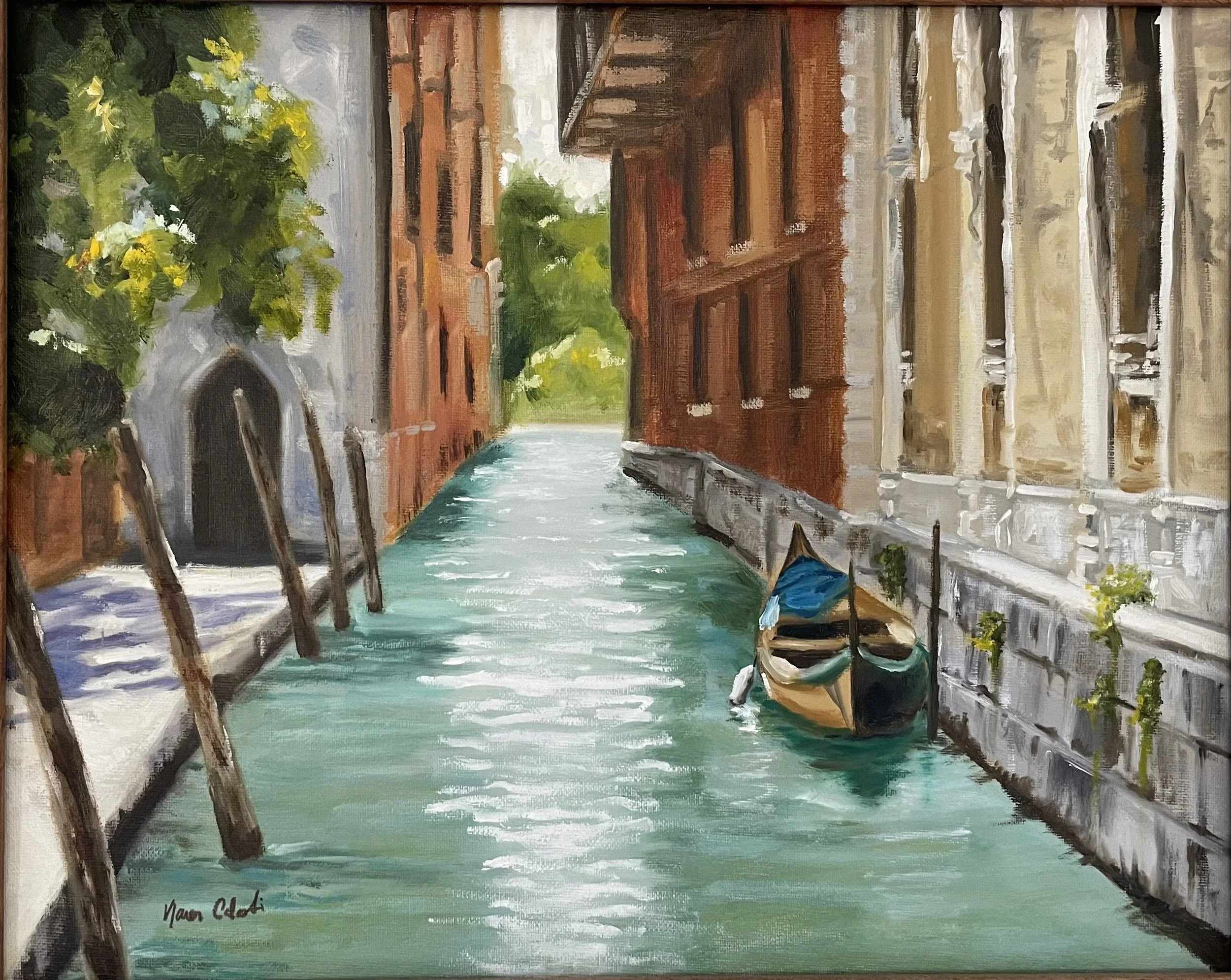 Painting of a canal scene in Venice with a small boat tied to a building on the right, tall brick and stone buildings on both sides, green water, and lush green trees in the background. Bright sunlight reflects on the water.