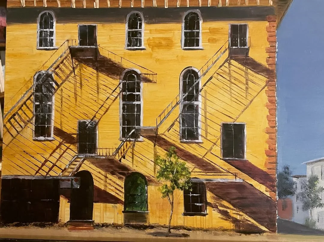 Painting of a yellow brick building with black fire escapes on the front, featuring several windows and a small tree in front.