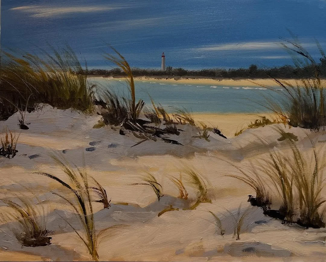 A painting of a beach scene with sand dunes, grassy plants, water, a lighthouse in the distance, and a cloudy sky.