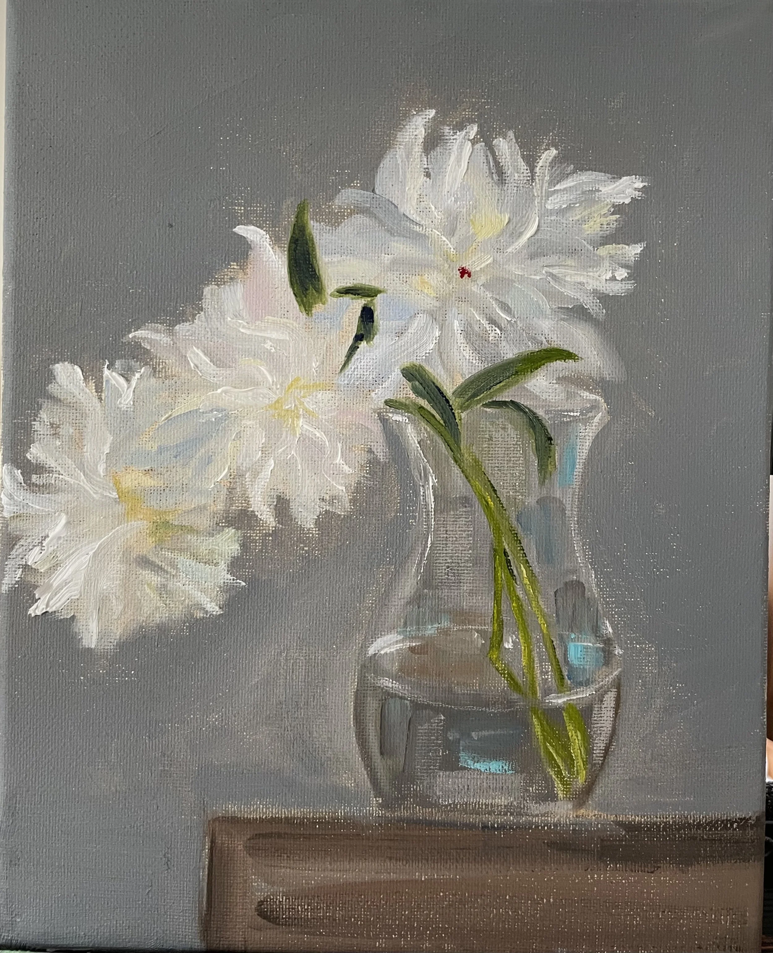 A painting of white lilies in a clear glass vase on a wooden surface against a gray background.