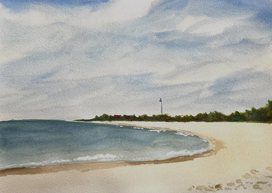 A watercolor painting of a beach with gentle waves, a sandy shoreline, green trees, a lighthouse in the distance, and a cloudy sky.