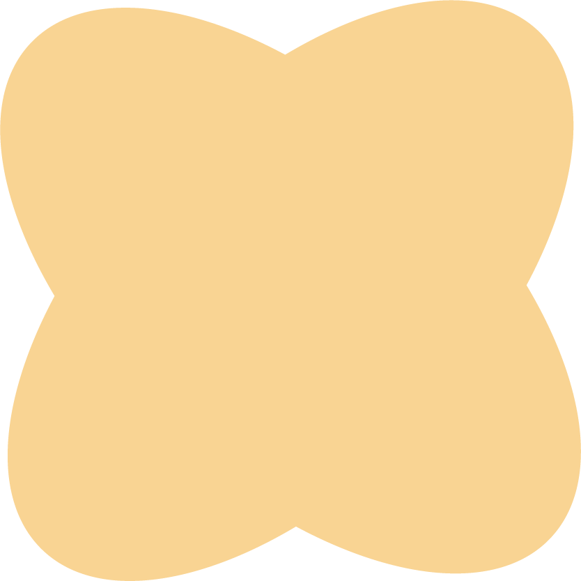 A beige four-leaf clover-shaped object with rounded petals on a black background.