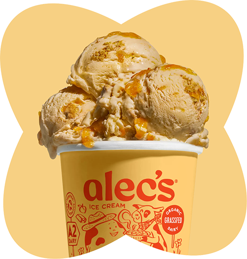 A cup of Ale¿s organic grass-fed dairy ice cream with three scoops, topped with caramel sauce.