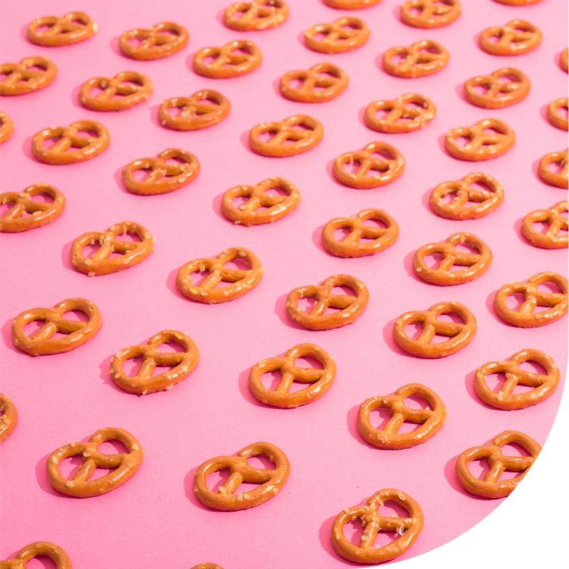 Image of pretzels in repeating pattern on a pink background