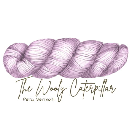 A lavender-colored skein of yarn with the text 'The Wholly Caterpillar Perry, Vermont' below it.