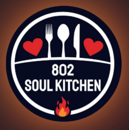 Logo for 802 Soul Kitchen featuring a fork, spoon, and knife with two hearts and a small flame, on a dark background.