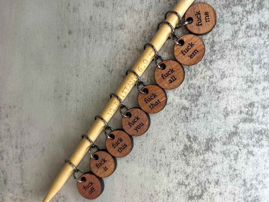 F-It stitch markers on a knitting needle
