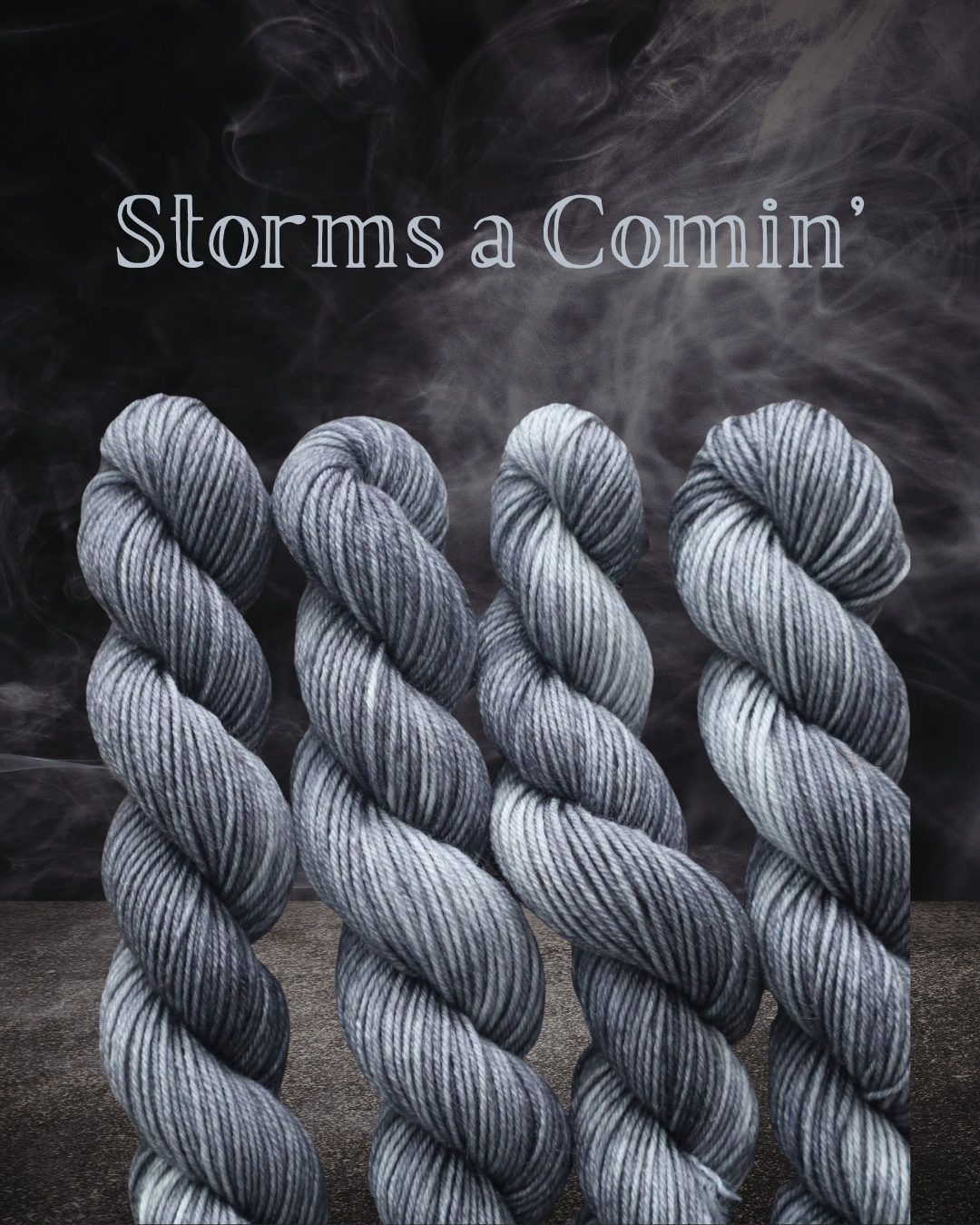 Four twisted skeins of black and gray striped yarn with smoke and the text 'Storms a Comin'' in the background.