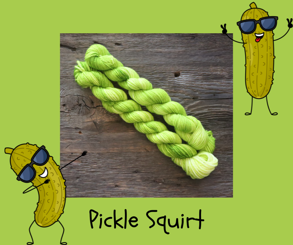 Two skeins of bright green yarn lying on a wooden surface and drawings of pickles in sunglasses with the text Pickle Squirt at the bottom.