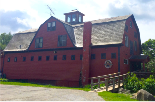 Picture of a large red barn with Grandma Millers Sign.