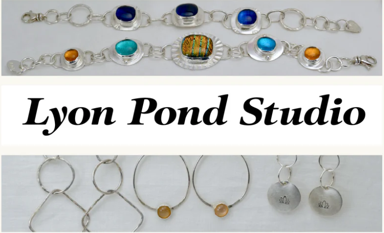 Jewelry display with two silver bracelets featuring colorful stones, a set of silver earrings with circular pendants, and a white banner with black text reading "Lyon Pond Studio".