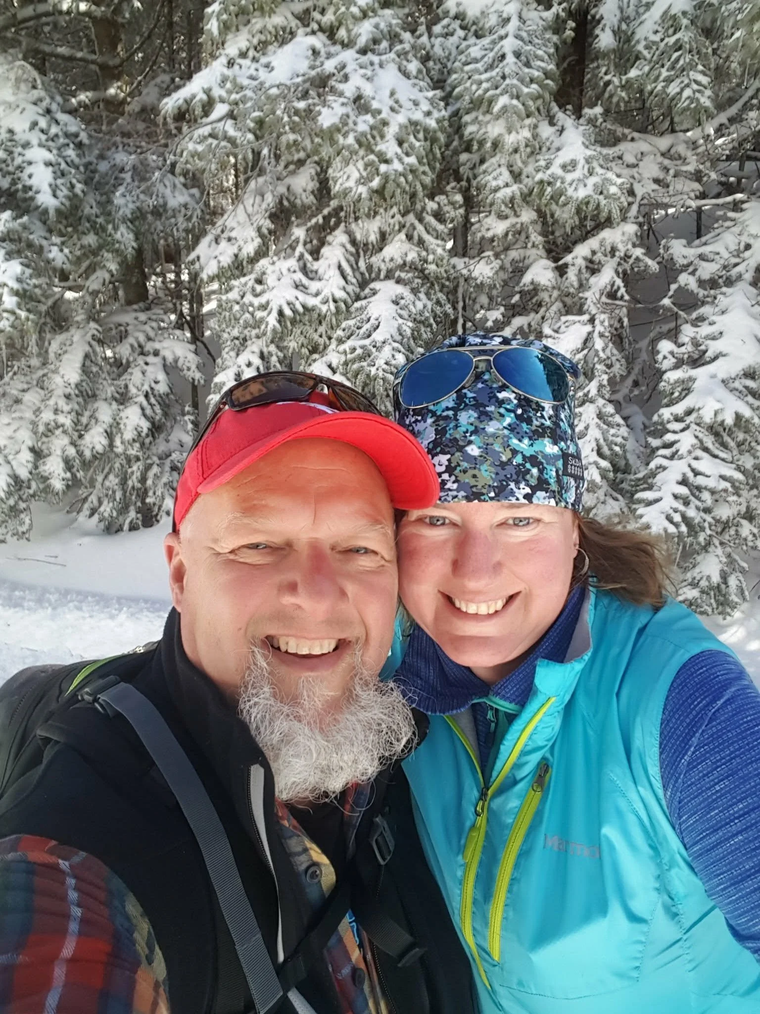 Image of Brian & Vicky in winter, smiling at the camera.