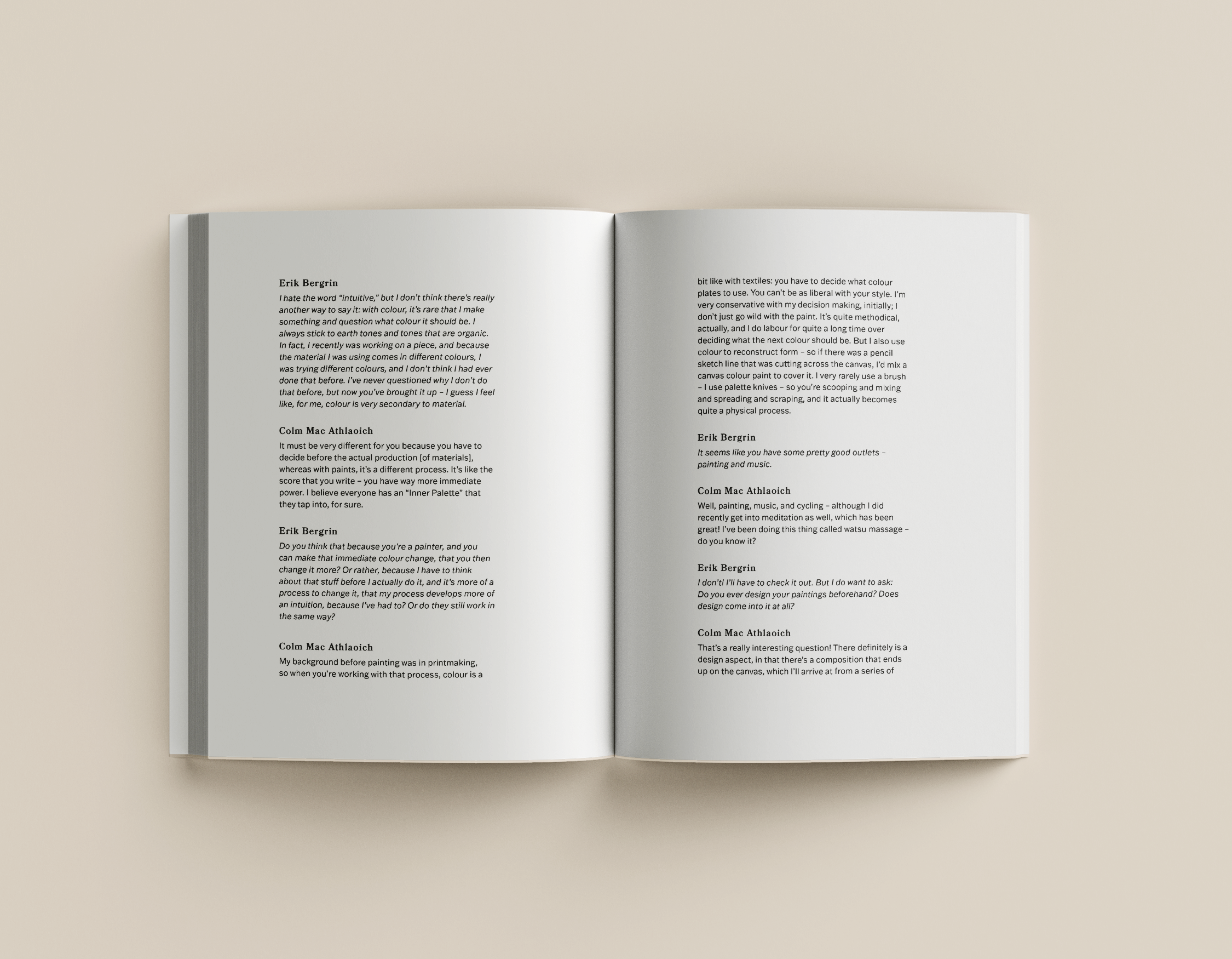 Open book with text on pages, resting on a beige surface.