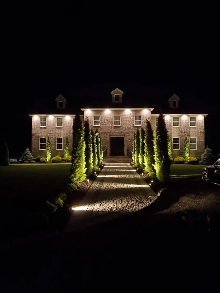 Outdoor living outdoor lighting design highlighting architectural features and landscape pathways in Lloyd Harbor, NY
