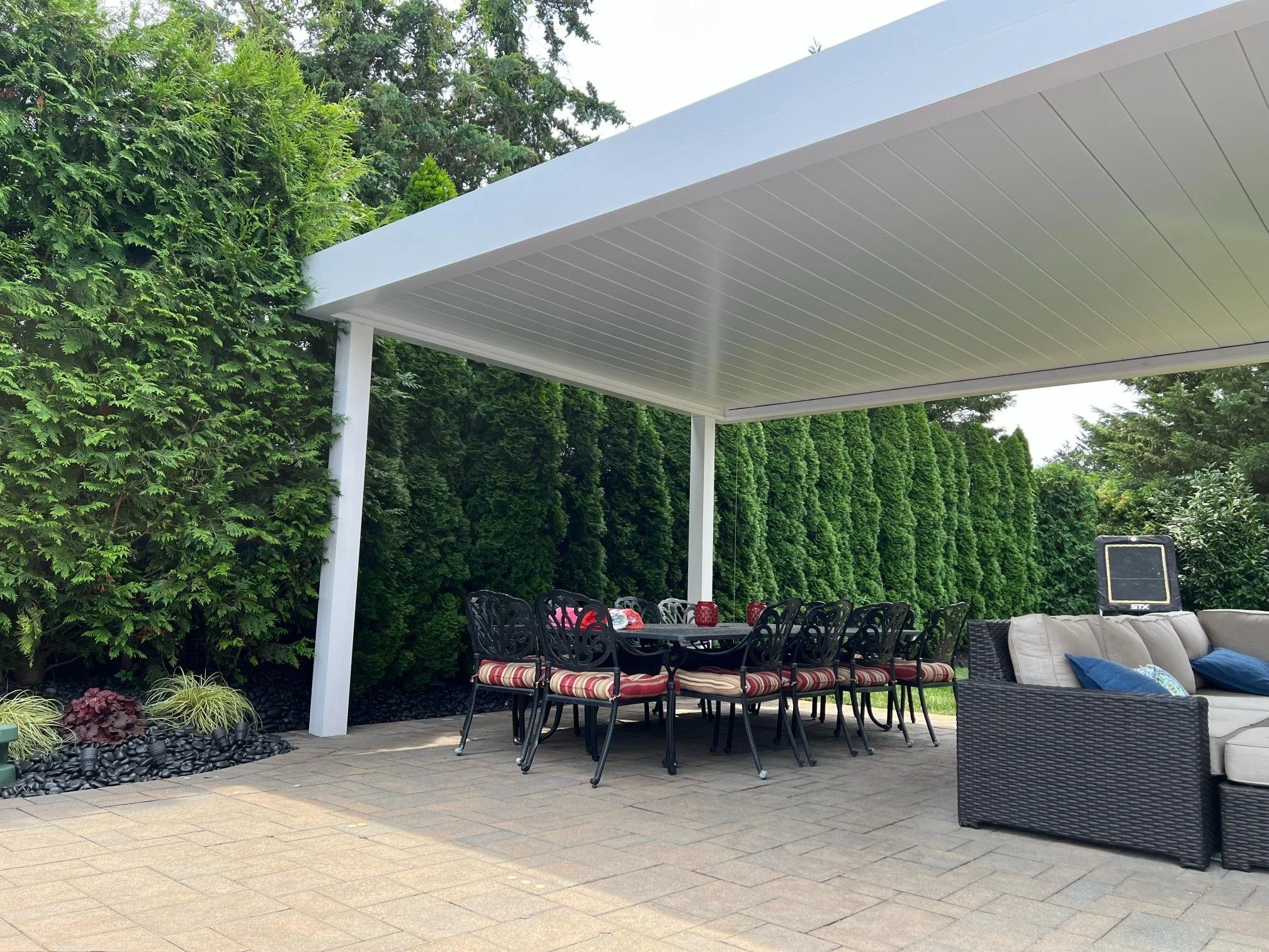 Modern louvered pergola installed over an outdoor seating area in Long Island, NY
