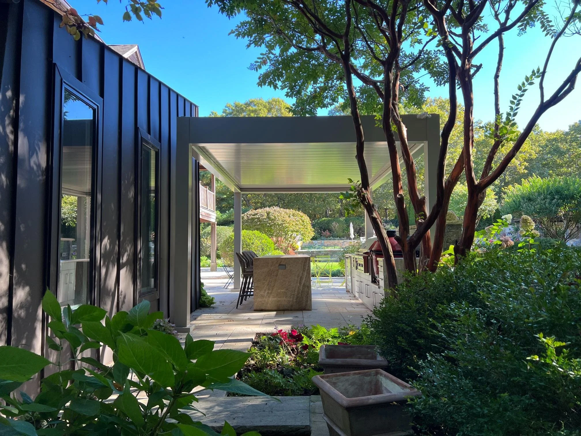 Louvered pergola covering a patio lounge with clean architectural lines in Long Island, NY
