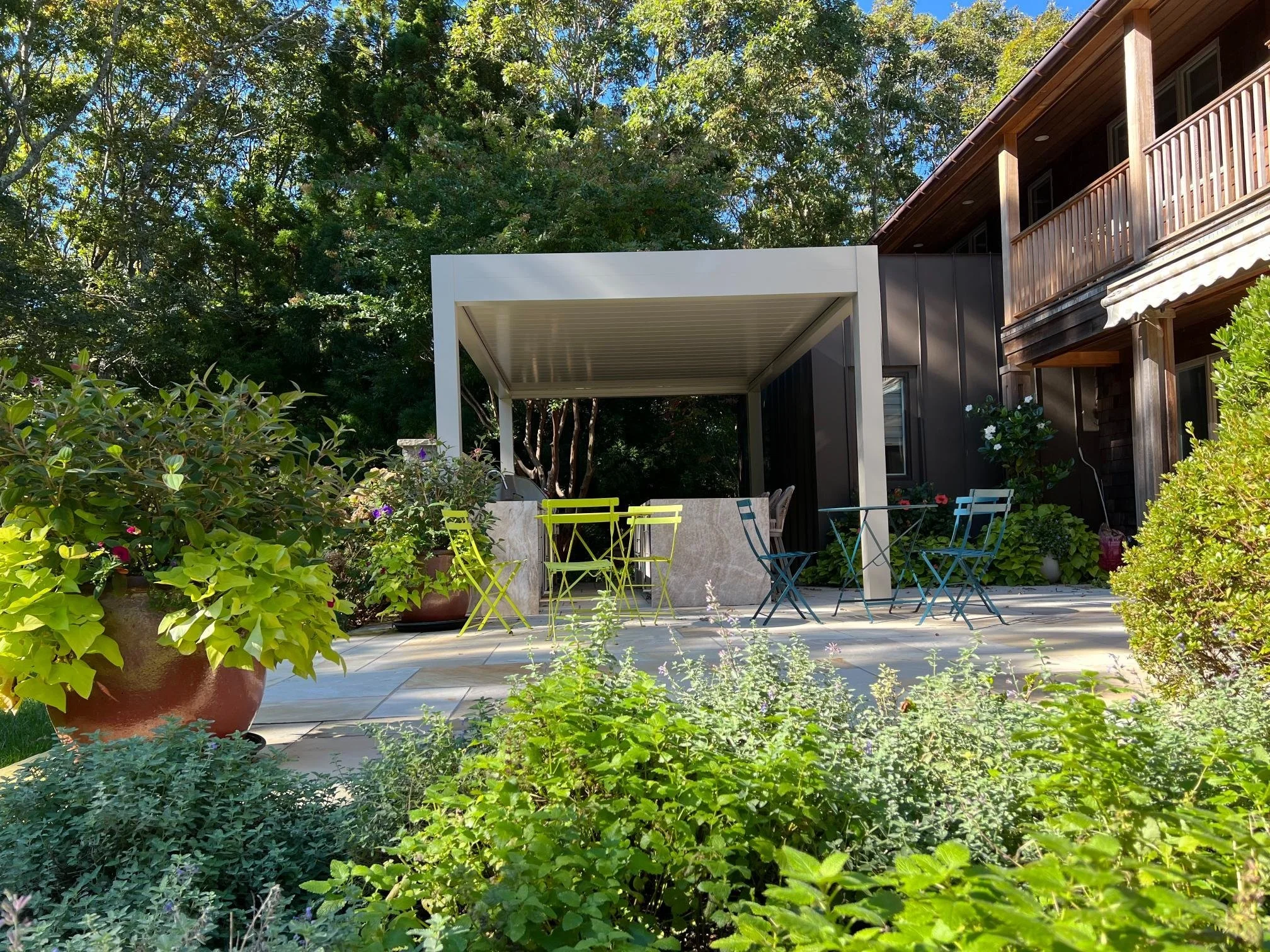 Contemporary louvered pergola integrated into a landscaped backyard in Long Island, NY