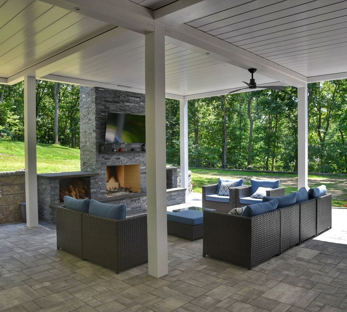 Louvered pergola providing controlled sunlight over an outdoor dining space in Long Island, NY