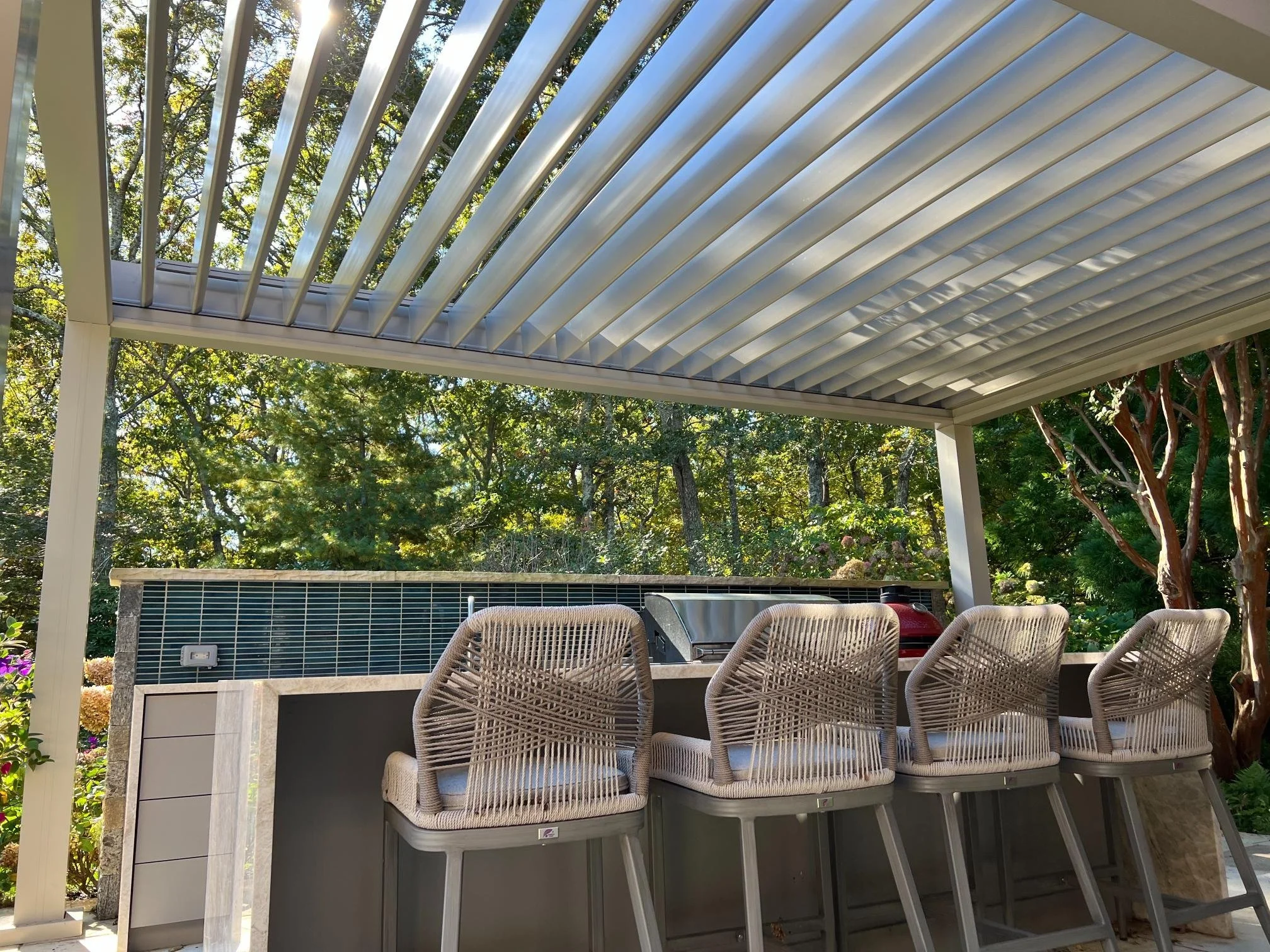Custom louvered pergola paired with modern outdoor furniture in Long Island, NY