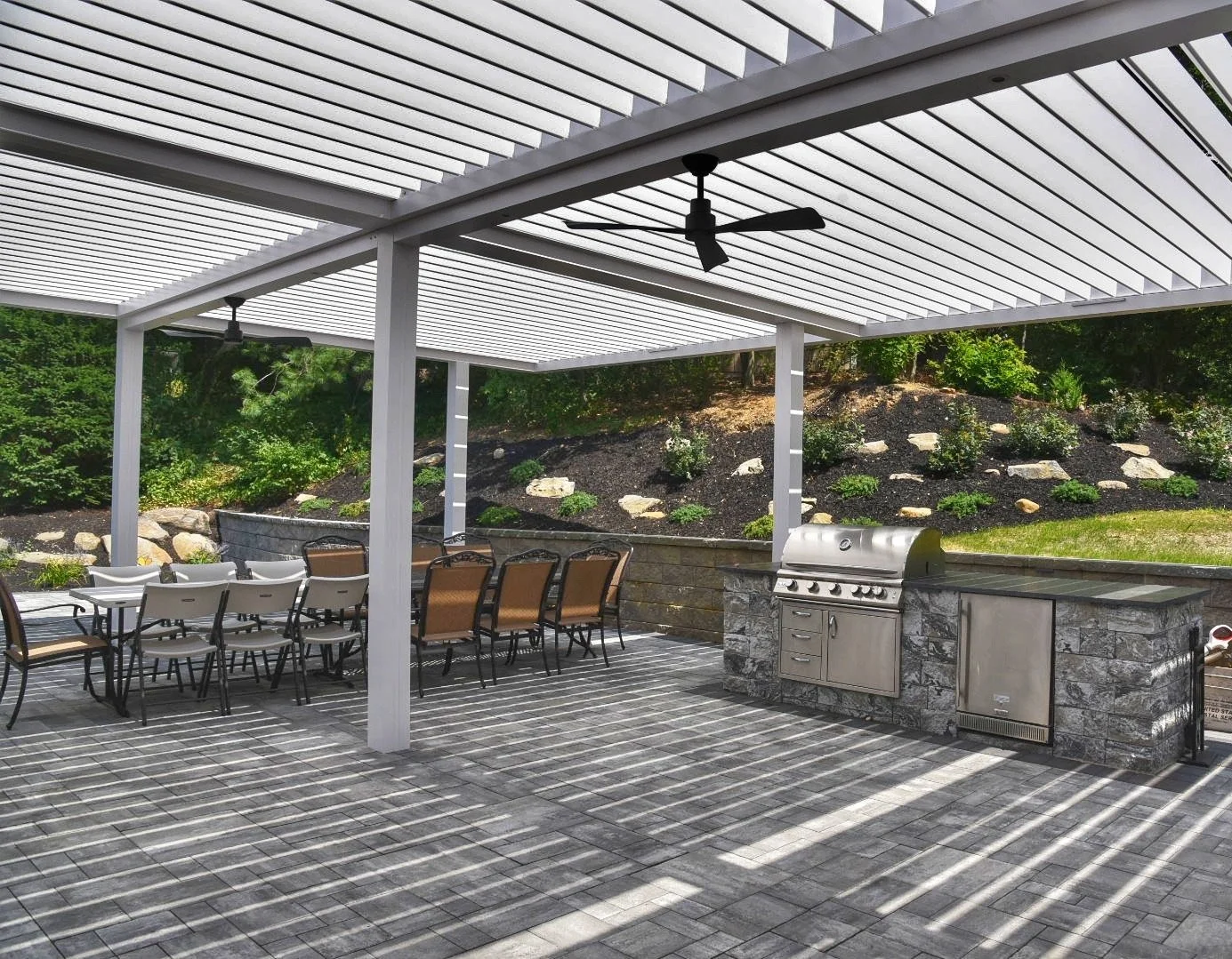 Louvered pergola structure creating a defined outdoor living zone in Long Island, NY
