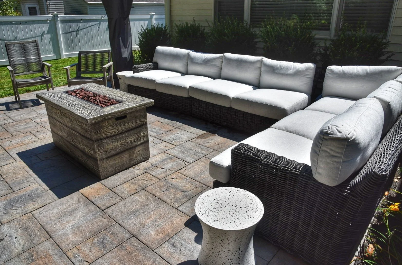 Custom masonry outdoor fireplace integrated into a landscaped patio in Port Washington, NY