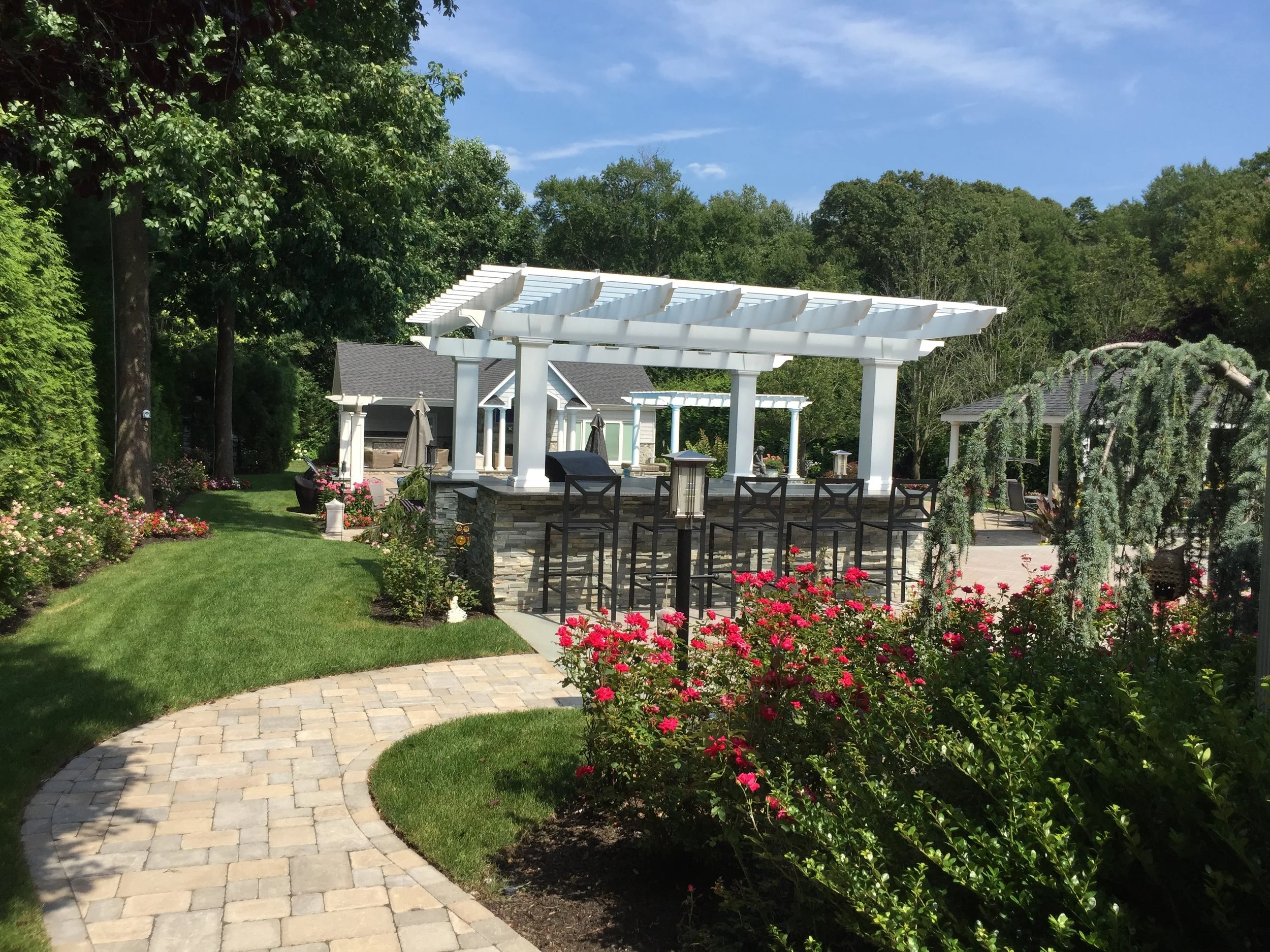 Custom outdoor kitchen with built-in grill and prep space designed for backyard entertaining in Babylon, NY