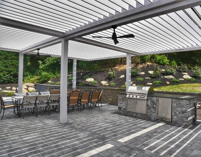 Covered outdoor kitchen designed for refined backyard entertaining in Manhasset, NY