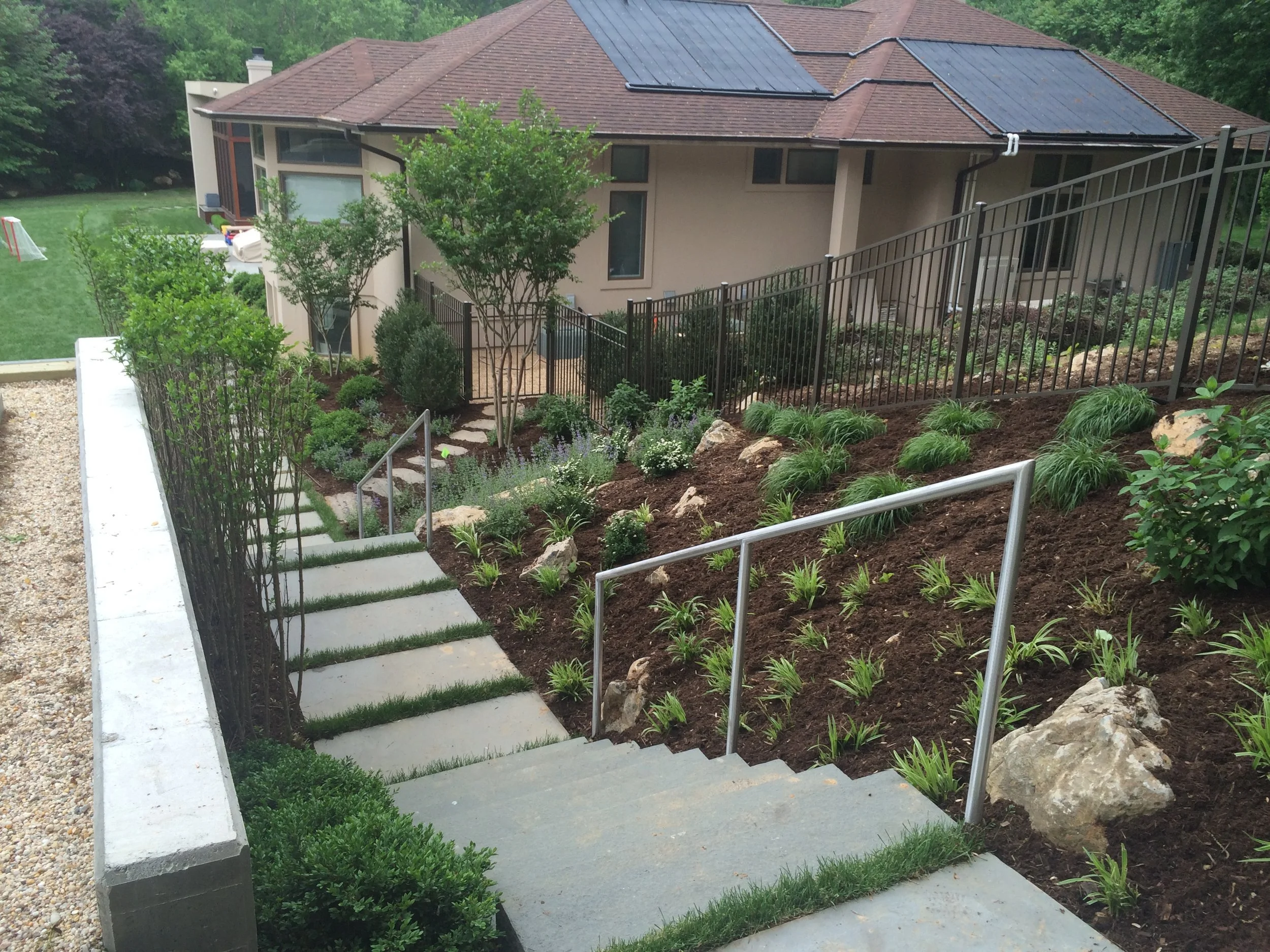 Plantings enhancing the overall flow of the outdoor design in Port Washington, NY