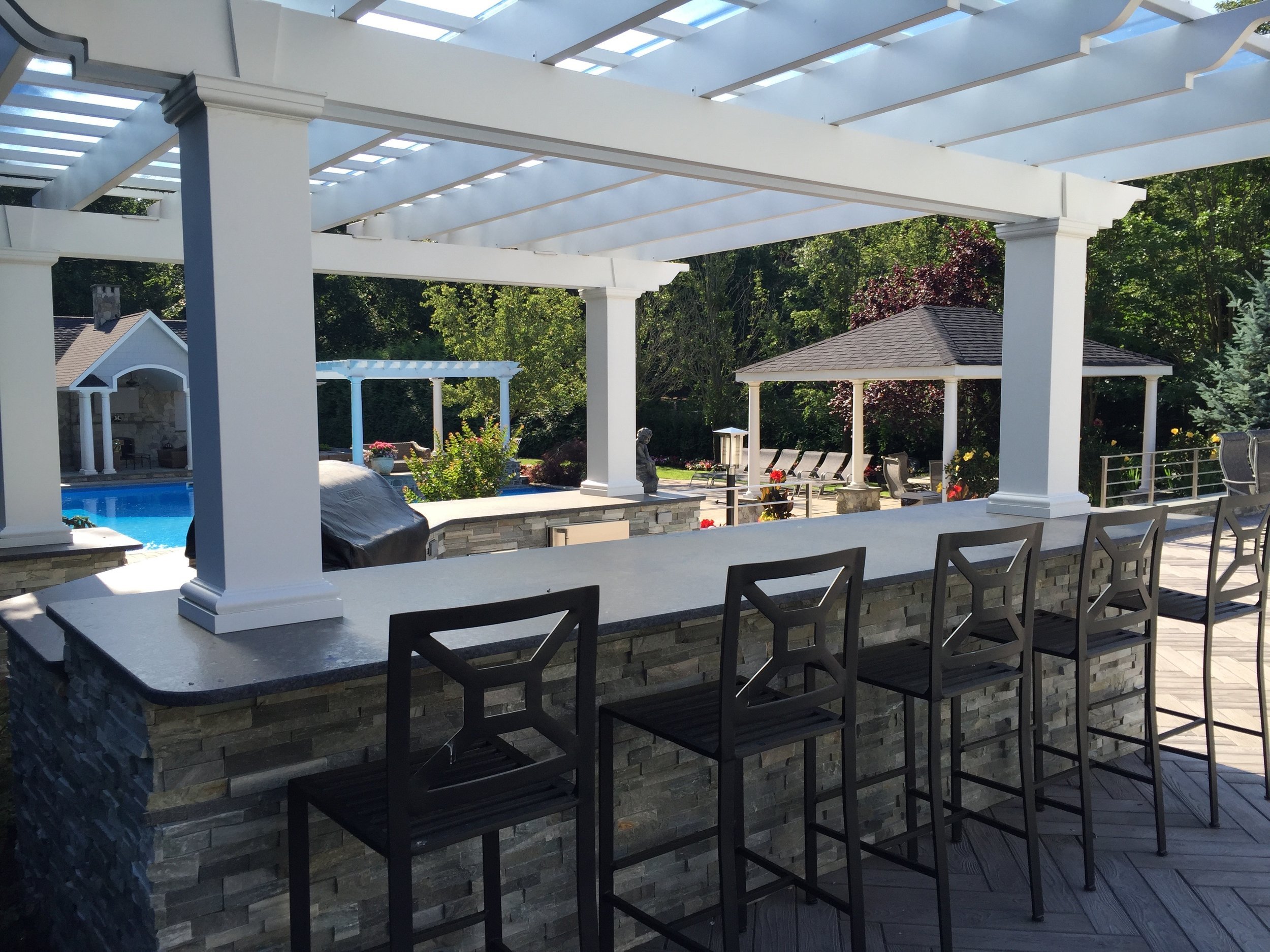 Create the Experience of an Outdoor Room with a Pergola in Syosset