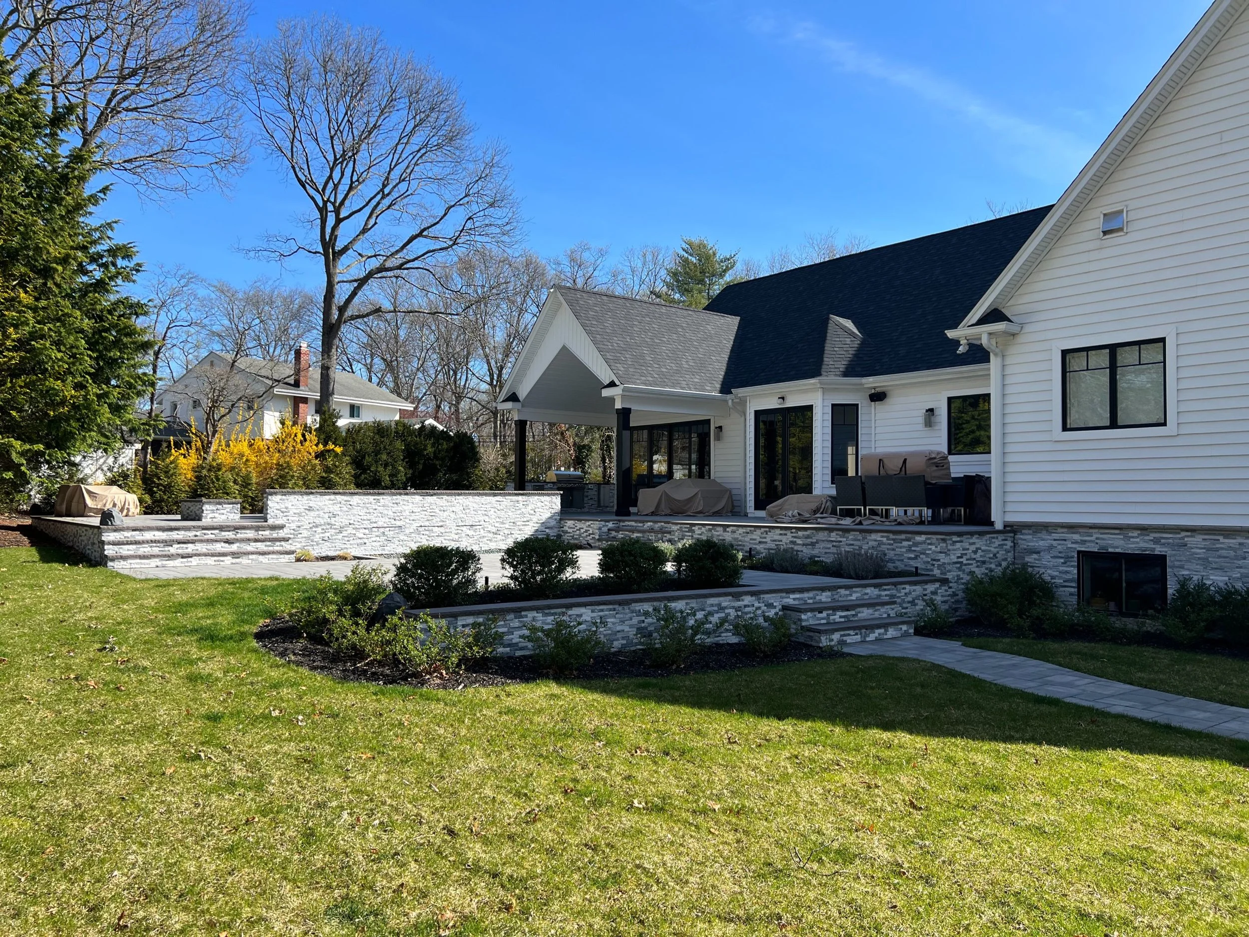 Stone veneer masonry enhancing outdoor architecture and home exterior character in Sands Point, NY