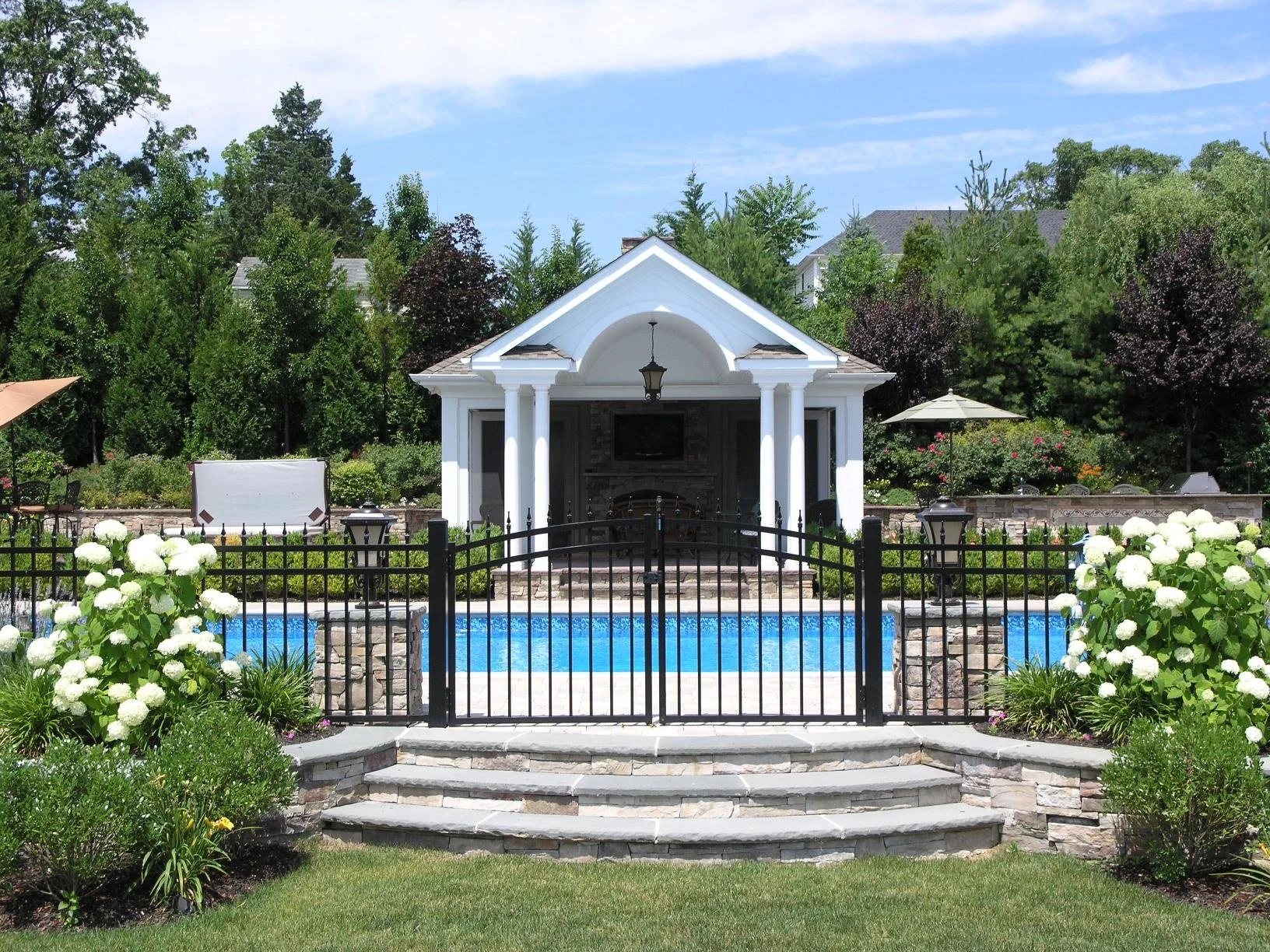 Cabanas creating a comfortable poolside escape at a Huntington, NY home