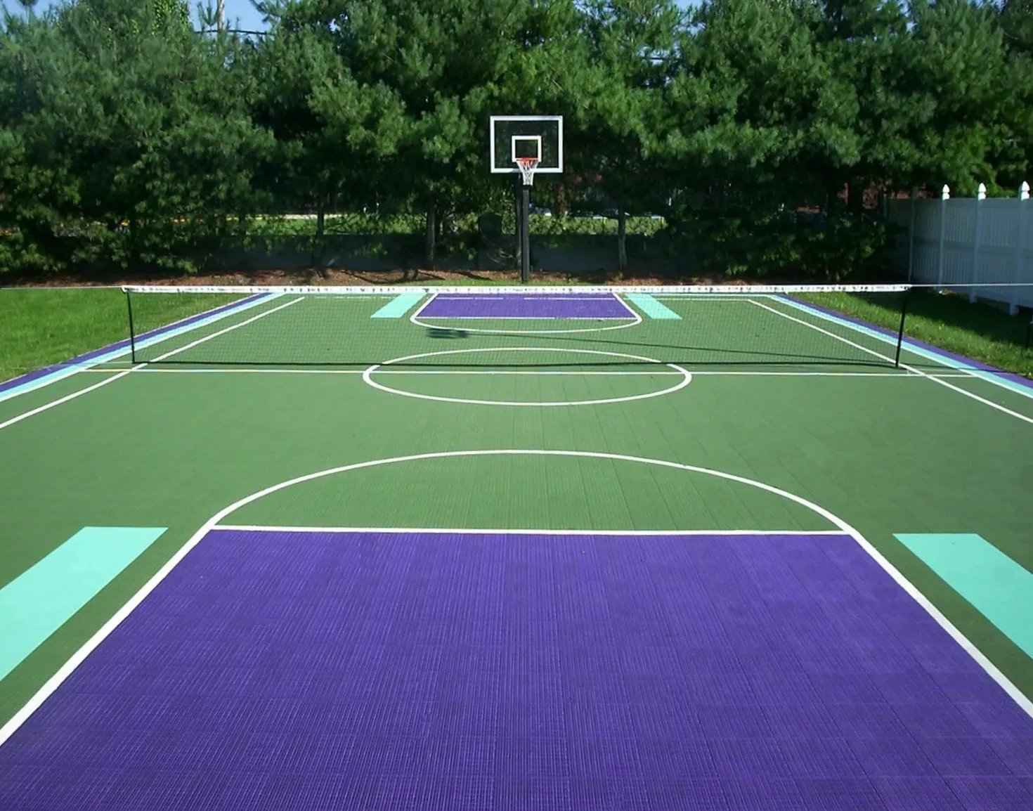 Backyard court integrated into a larger patio and planting layout in Port Washington, NY