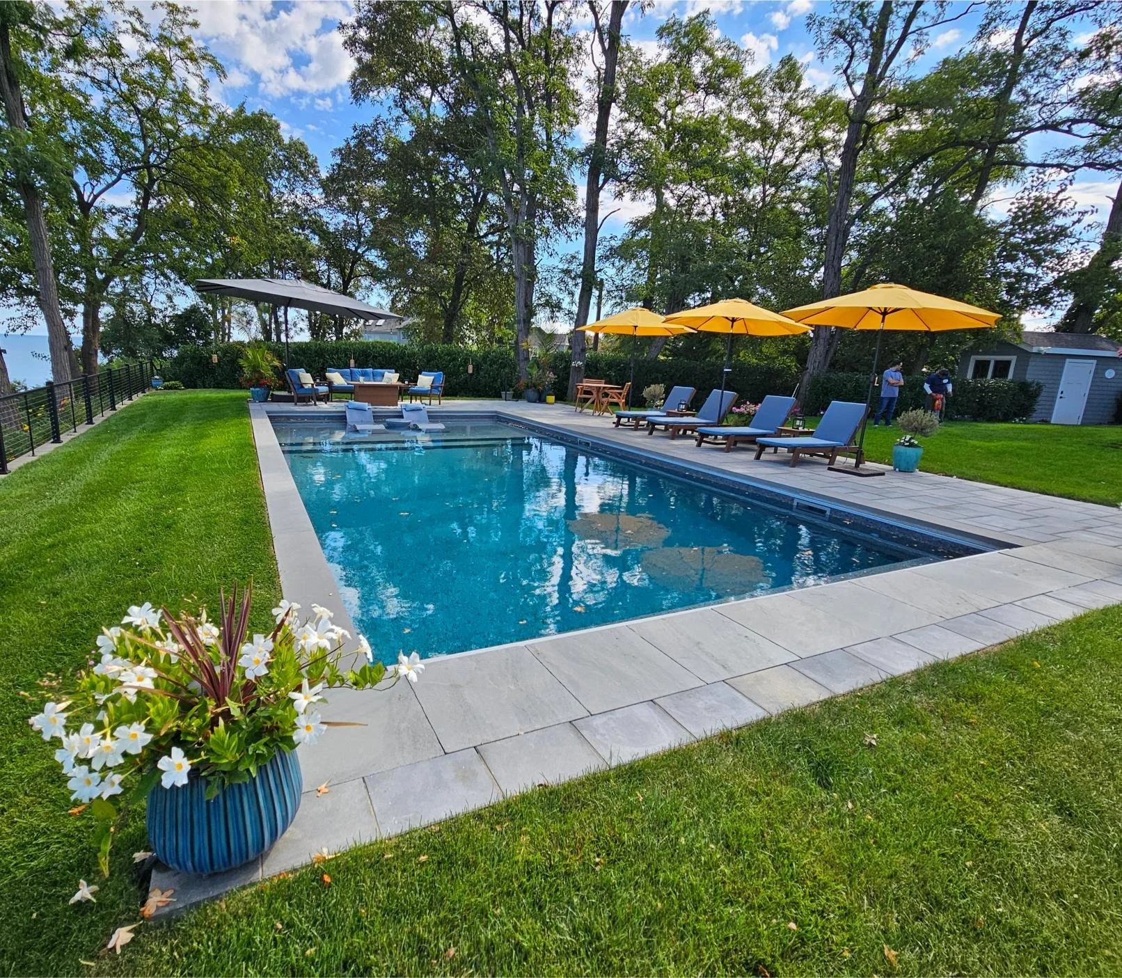 Outdoor living pool and poolscape design with custom swimming pool and patio layout in Northport, NY