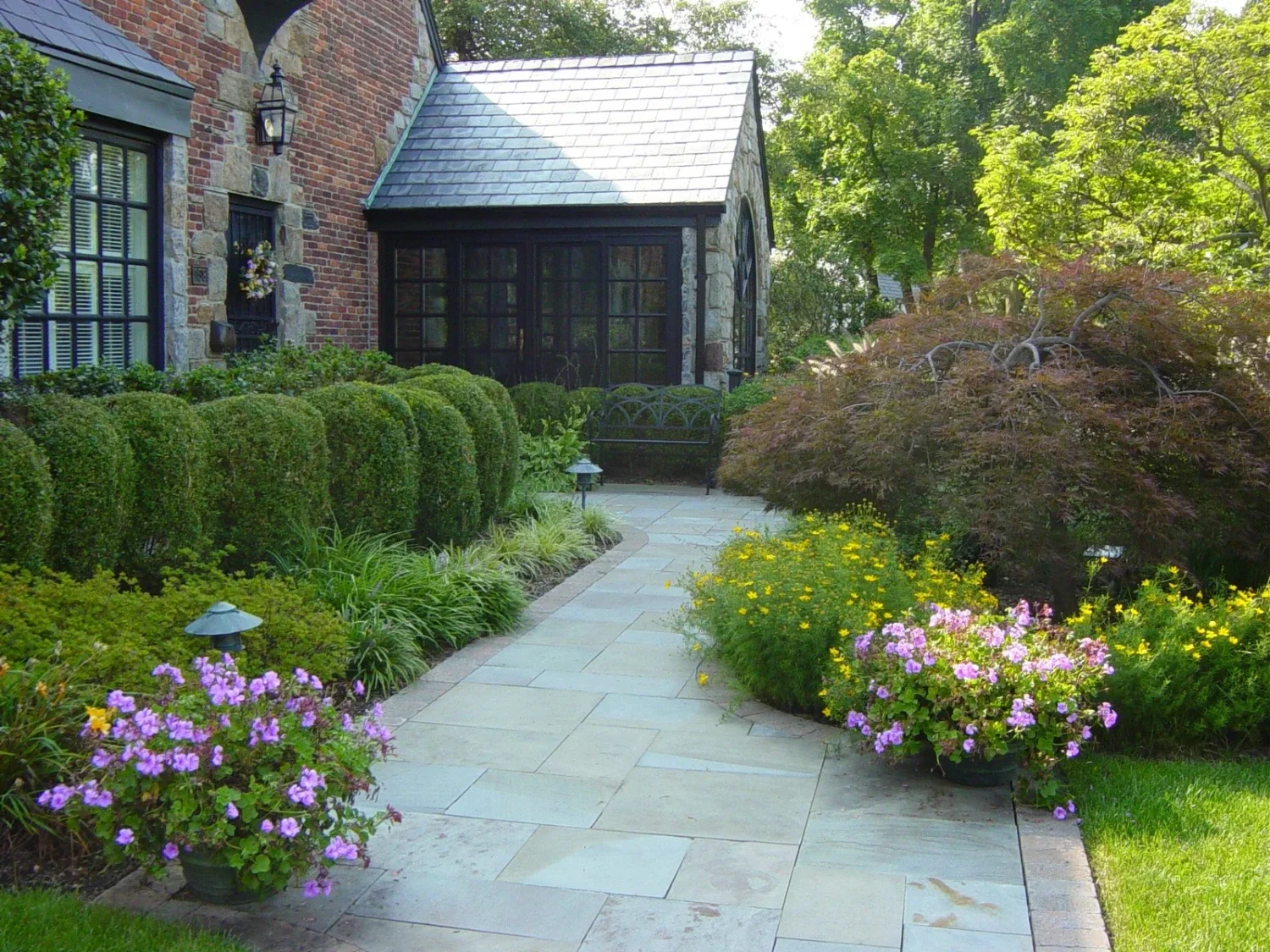 Stone walkway design guiding movement through landscaped outdoor living spaces in Setauket, NY