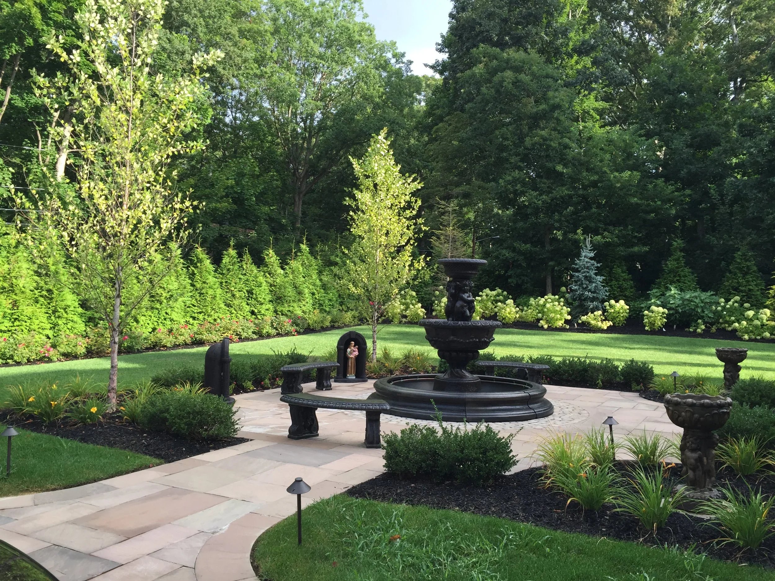 Architectural landscaping featuring formal symmetry, water features, and structured garden spaces in Sands Point, NY