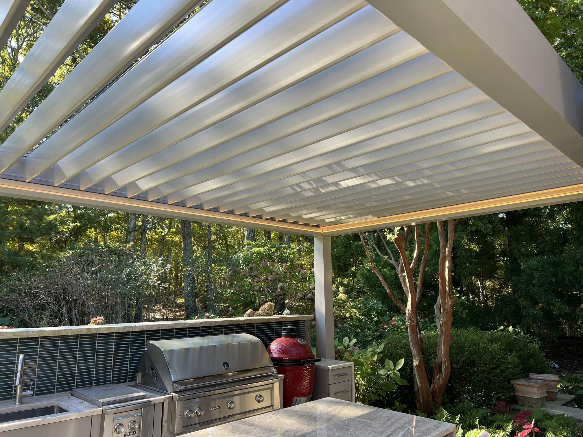 Modern Azenco pergola with adjustable louvers providing flexible outdoor shade in East Norwich, NY