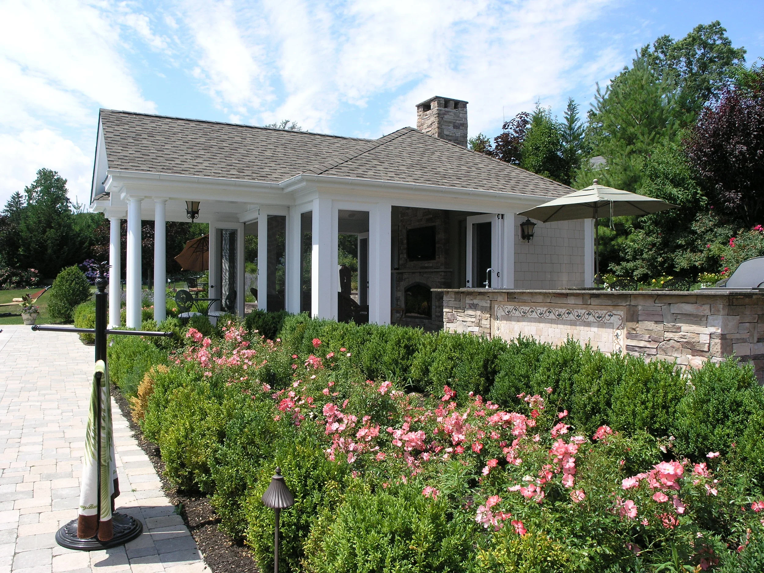 Architectural landscaping integrating hardscape elements and plantings in Sands Point, NY