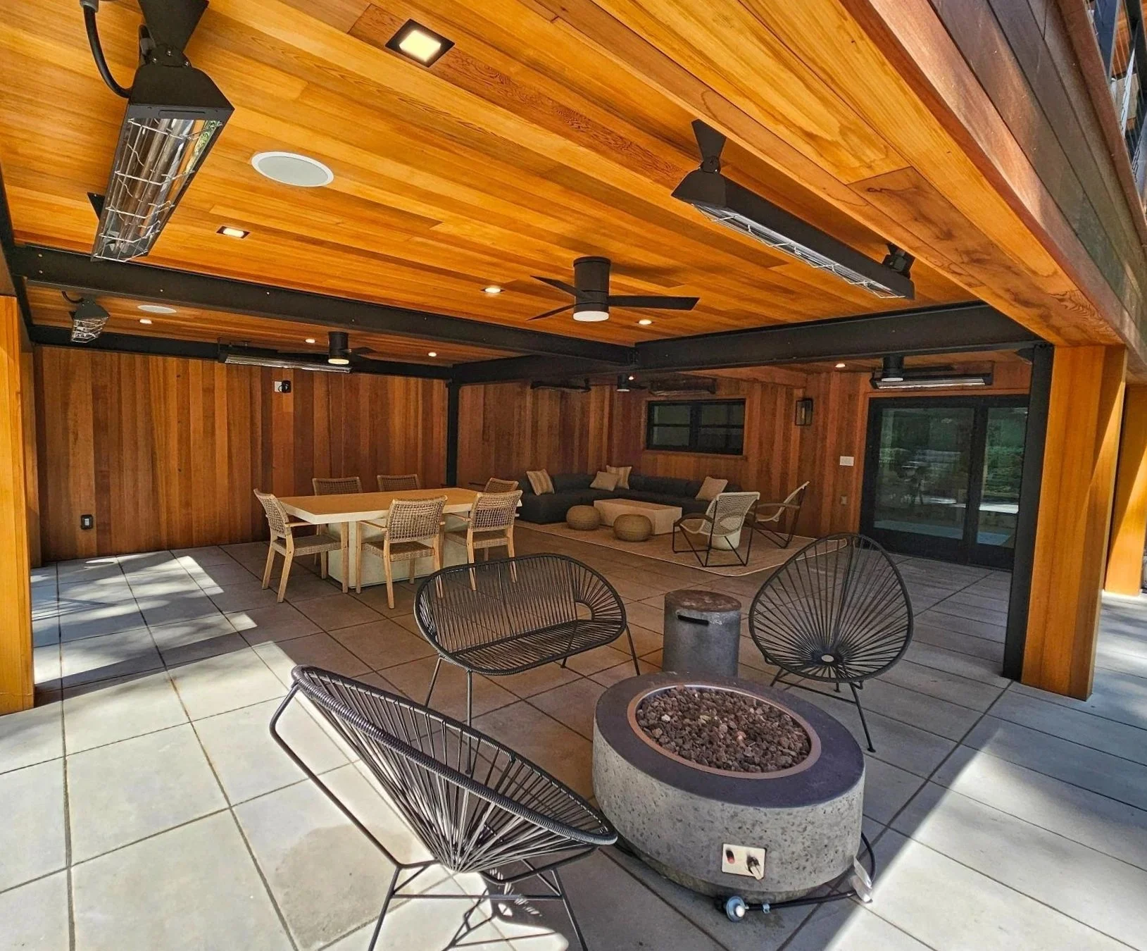 Covered outdoor pavilion with wide stone steps and shaded seating area in East Norwich, NY