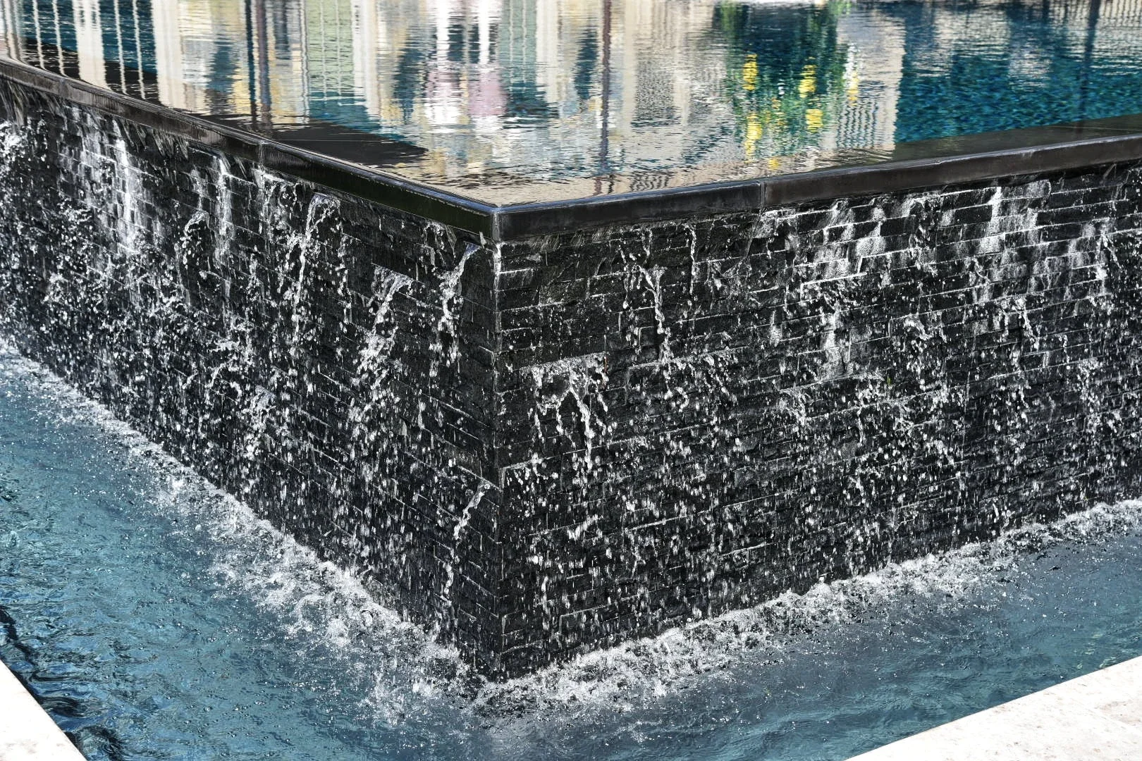 Natural stone waterfall feature included in a financed landscape design project in Oyster Bay, NY