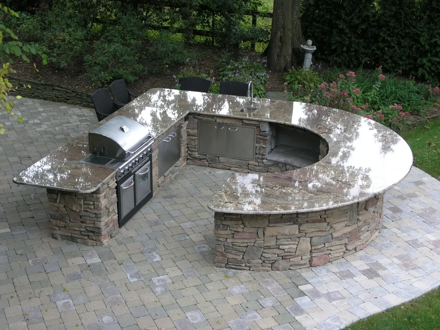 Outdoor kitchen island designed for prep, serving, and gathering with durable stone surfaces in Cold Spring Harbor, NY