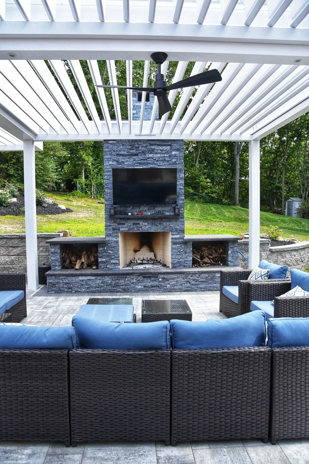Stone fire pit on a paver patio designed for evening gathering in Southampton, NY